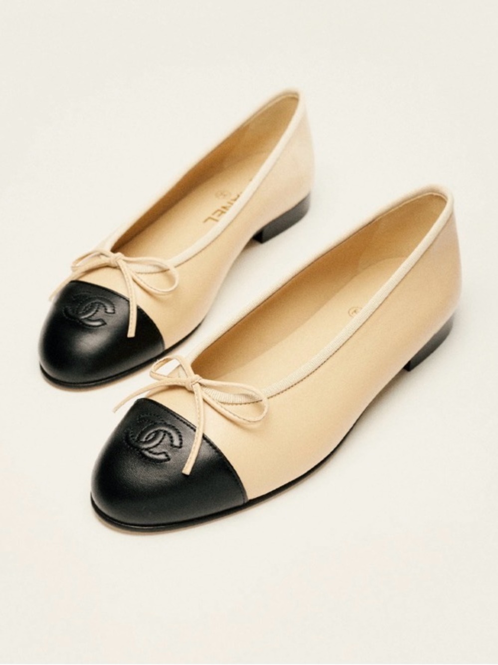 CHANEL Beige Leather Ballet Flats with Black Cap Toe and Bow